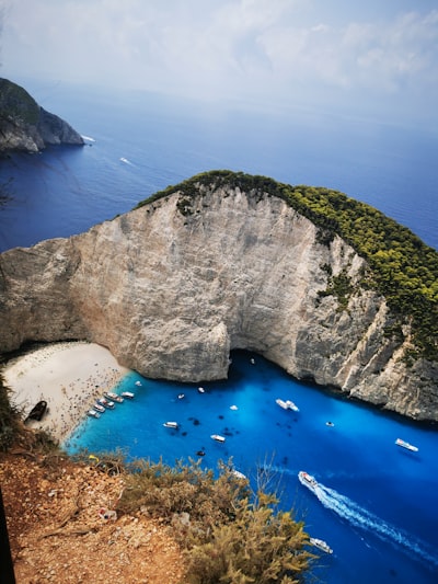 a rocky cliff with a body of water below